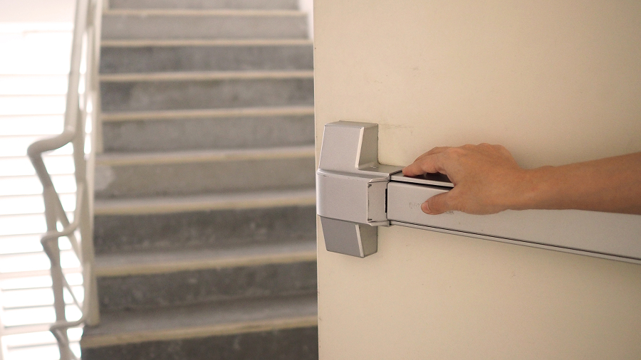 Hand on door fire push handle